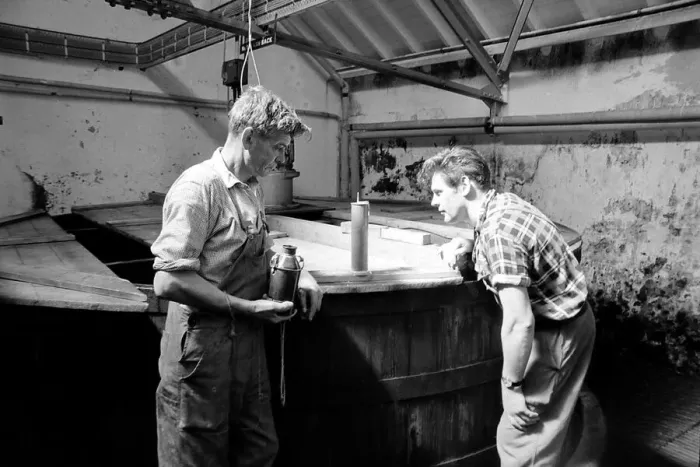 Framed Print : Workers inspect the malt grist in the Mash tun at the Knockando Whisky Distillery Framed Print : Workers inspect the malt grist in the Mash tun at the Knockando Whisky Distillery