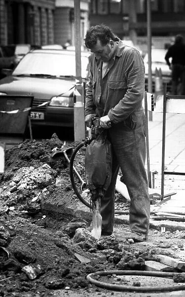 A workman on the 6th March 1989 using a pneumatic drill