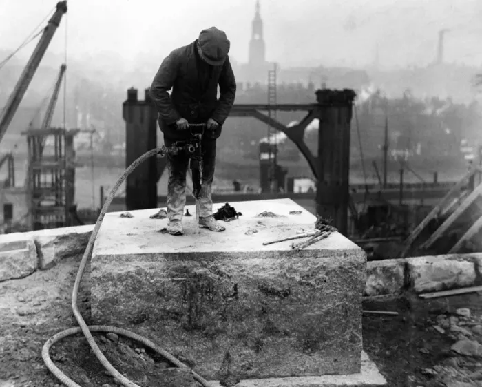 Framed Print : A workman drilling holes in one of the bedstones on the Gateshead abutment for