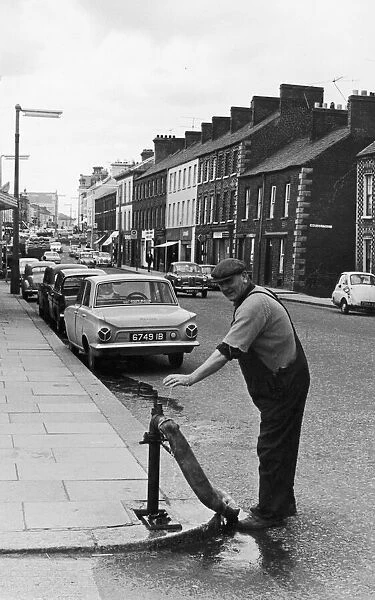 A workman from the local water board seen here working a standpipe in Portadown