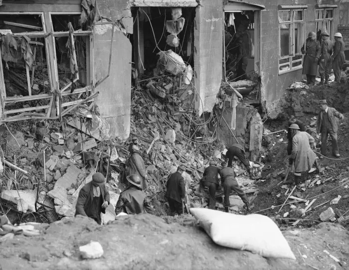 Framed Print : Workman and rescue workers search through the rubble and shell of the Coventry