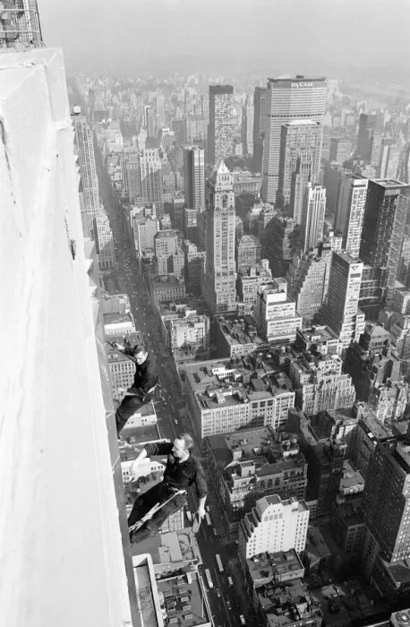 Framed Print : Workmen busy cleaning windows 1000 ft up the Empire State building in Manhatten New York