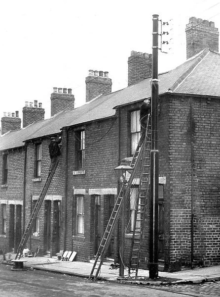Workmen busy at the poles erected in Shield Street, Gateshead where they are putting