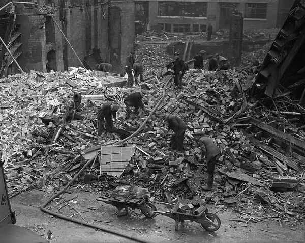 Workmen clearing up and sifting through the remains of the Corn Exchange, Carrs Lane