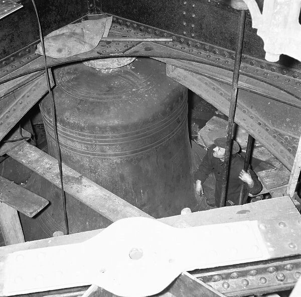 A workmen inspects the bell Big Ben during the major overhaul of all the bells