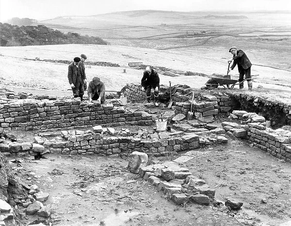 Workmen repair and tidy the remains of the Roman fort at Housesteads in Northumberland in