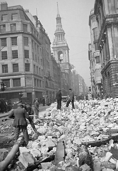 Workmen sift through the debris following the previous nights air raid on Central London