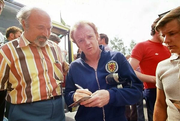 World Cup 1974 Billy Bremner signing autographs after a Scotland training