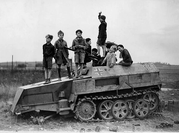 World War 2 1944 Children play on a knocked out German half track armoured vehicle