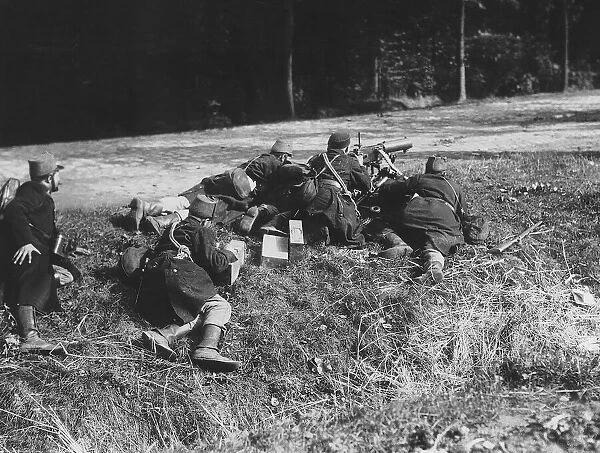 World War One - Belgian soldiers man a machine gun on the edge of a road as part of