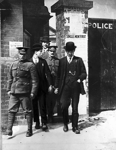 World War One - Two conscientious objectors, escorted from police station in handcuffs