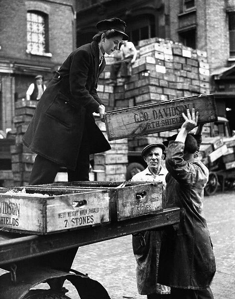 World War Two Home Front. A woman delivery boxes full of fish to traders in Billingsgate