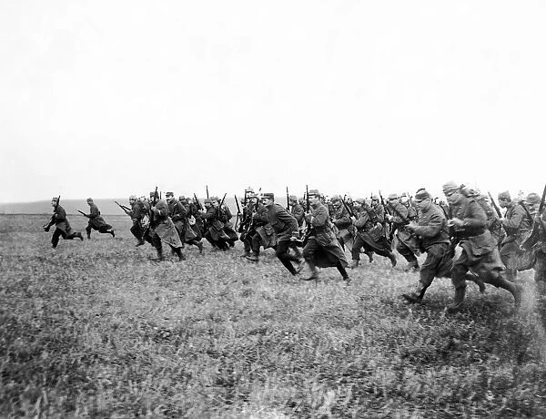 World War I French Soldiers charge across a field with rifles raised circa 1916