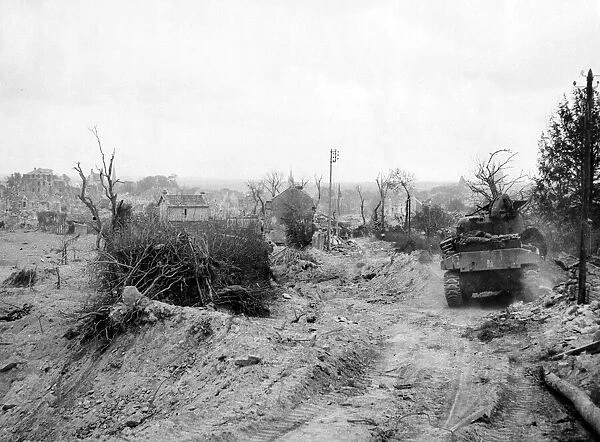 World War II Invasion of France A British army Sherman tank moves along
