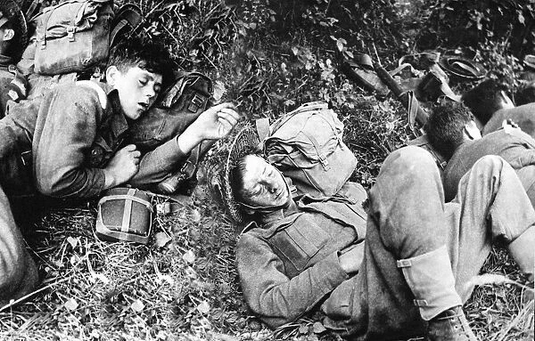 World War II Invasion of France Canadian troops rest under a hedge in the Normandy