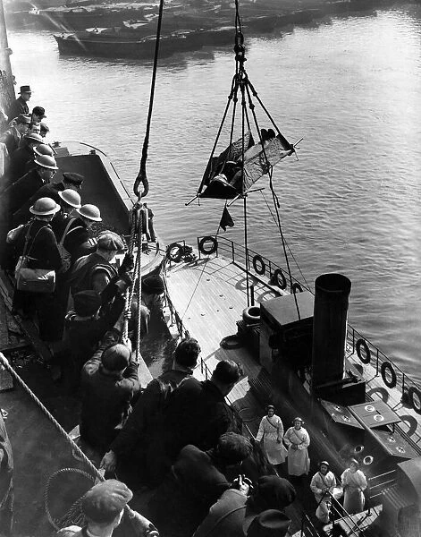 World War II: Medical. Hospital Ship (E). Injured seaman being lowered to deck of