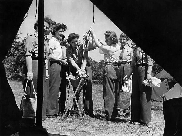 World War II Women: A. T. S. girls on holiday. Women washing their smalls outside their