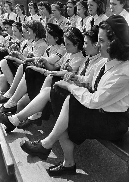 World War II Women: Girls of the G. T. C learn morse by tapping their fingers on the back