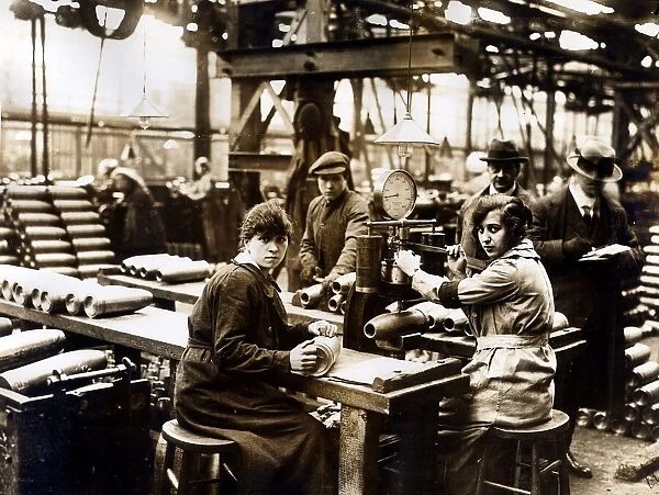World War One - munition factory making shells, women weighing steel shells