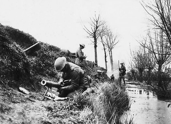 World War One- a British soldier repairs a machine gun in a trench on the British