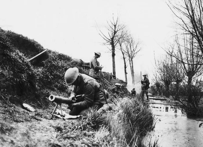 Framed Print : World War One- a British soldier repairs a machine gun in a trench on the British Framed Print : World War One- a British soldier repairs a machine gun in a trench on the British