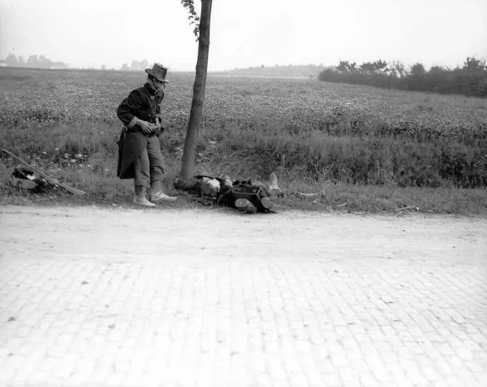 Framed Print : World War One. A wounded Belgian soldier falls by the roadside in 1914 Framed Print : World War One. A wounded Belgian soldier falls by the roadside in 1914