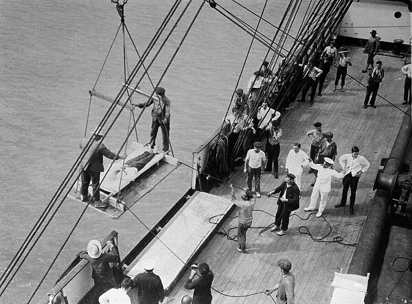 World War One. A wounded man on a stretcher is lifted on board a hospital ship