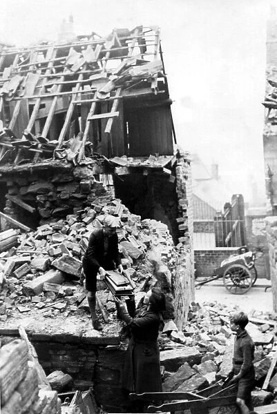 World War Two - Second World War - A family salvage some belongings from the debris of