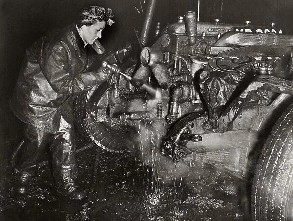 World War Two. Mrs M Bryan dressed in protective clothing cleaning dirt