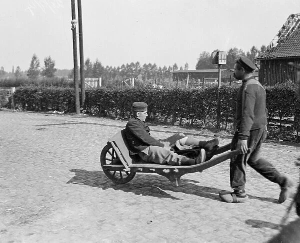 A wounded Belgian soldier is wheeled away from the battlefield close to the town of