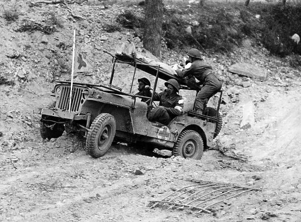 A wounded soldier is transported by jeep back to a Regimental Aid Post