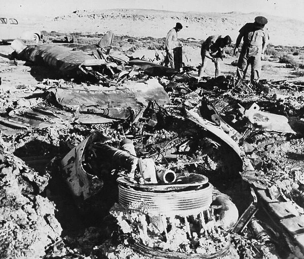 The Wreckage of a Heinkel III, lies burned out and twisted at the edge of a salt lake