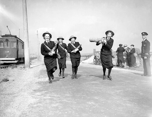 Wrens carrying shells to a shore battery on the South Coast 1941 Women doing mens