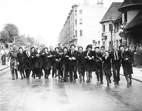 WRENS sailors and soldiers dance in the street in Brighton on VE Day, the end of WW2