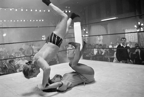 Wrestler Jackie Pallo is thrown head over heels by Gigi Gattri during the filming of