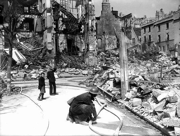 WW2 Air Raid Damage Bomb damage at Bath, children watch a firefighter at work