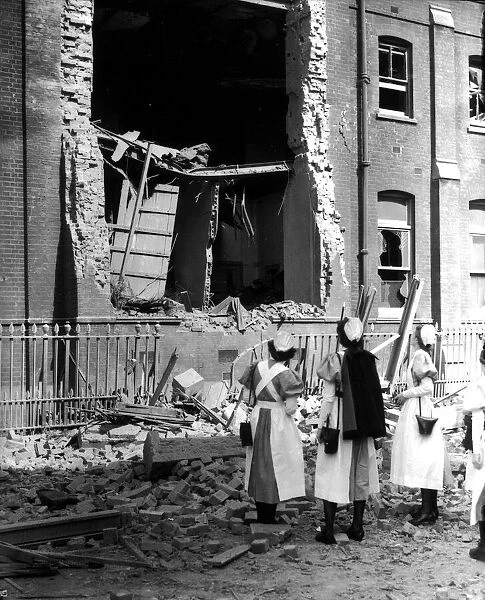 WW2 Air Raid Damage Nurses looking at a bombed hospital building during the blitz