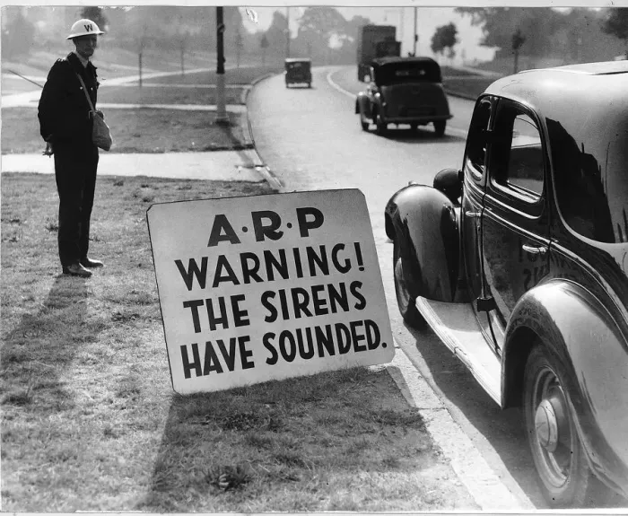 Framed Print : WW2 Air raid warden by road side Sept 40 warning notice for road users Framed Print : WW2 Air raid warden by road side Sept 40 warning notice for road users