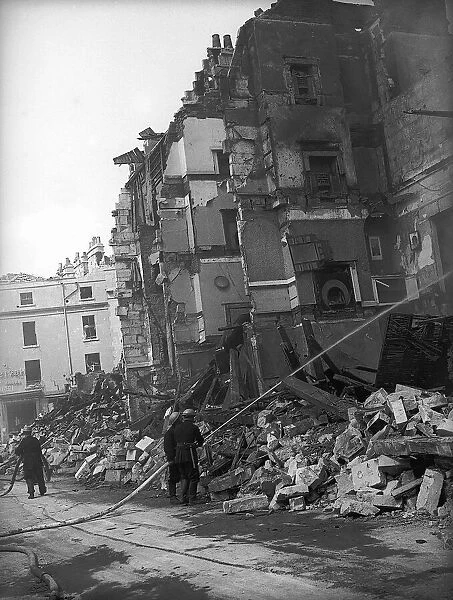 WW2 Bath Bomb Damage. Firemen pump water on the the damaged building 28th April 1942