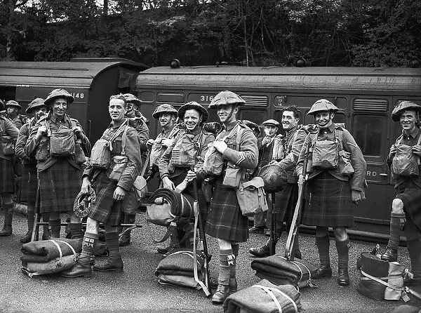 WW2 British Scottish Soldiers wearing army tunics and kilts with their kit prepare to