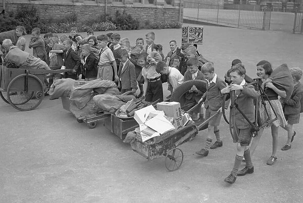 WW2 Children Evacuees Children carry and push along their belongings in improvised