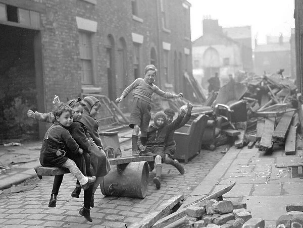 WW2 Children Playing Games Children make a see-saw out of an upturned dustbin