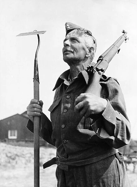 WW2 Home Guard carrying hoe and rifle May 40 first to enlist