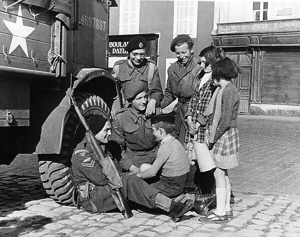 WW2 troops with French children Bayeaux Jul 44 in France children asking for