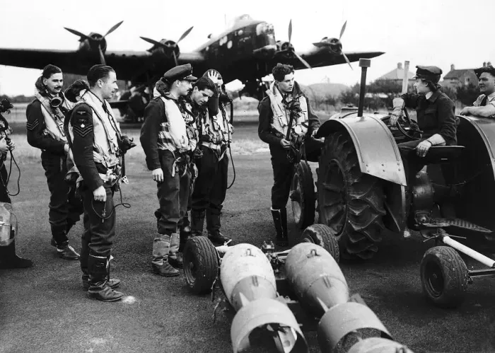Framed Print : WW2 WaF Auxiliary Air Force driver discusses the arming of a bomber with its crew