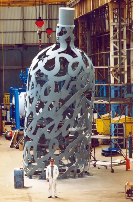 Framed Print : Yard electrician Peter Gilpin is dwarfed by the huge 35 foot metal bottle ordered by