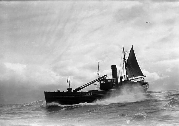 A Yarmouth Herring boat ploughing through a moderate swell in the North Sea. Circa 1935