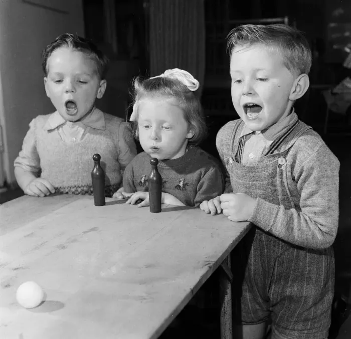 Framed Print : Four year old children of Bridgeton Day Nursery in Glasgow playing a game of blow