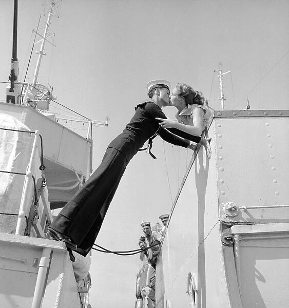 Twenty year old Engineer Mechanic Alan Purton of the Royal Navy stretches across the gap