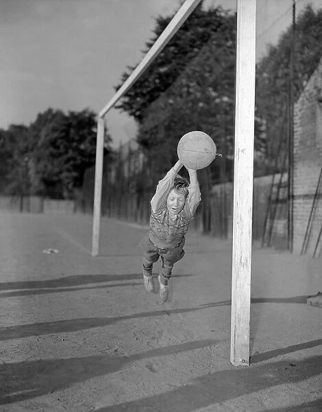 Ten year old George Welch makes a flying save while in goal for his school football team